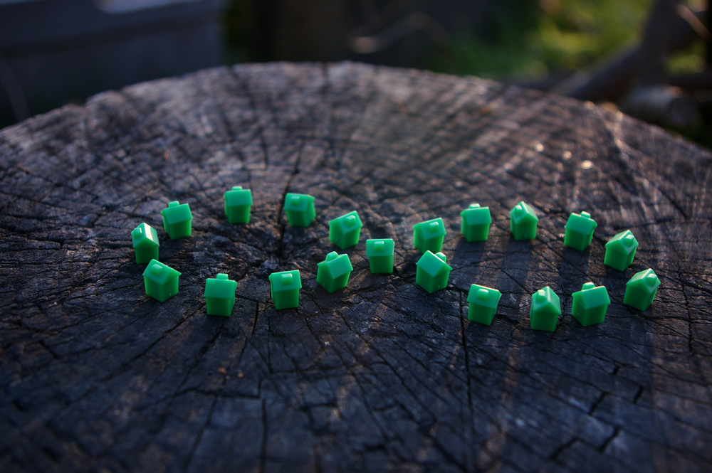 Green infinity symbol on a wooden log background