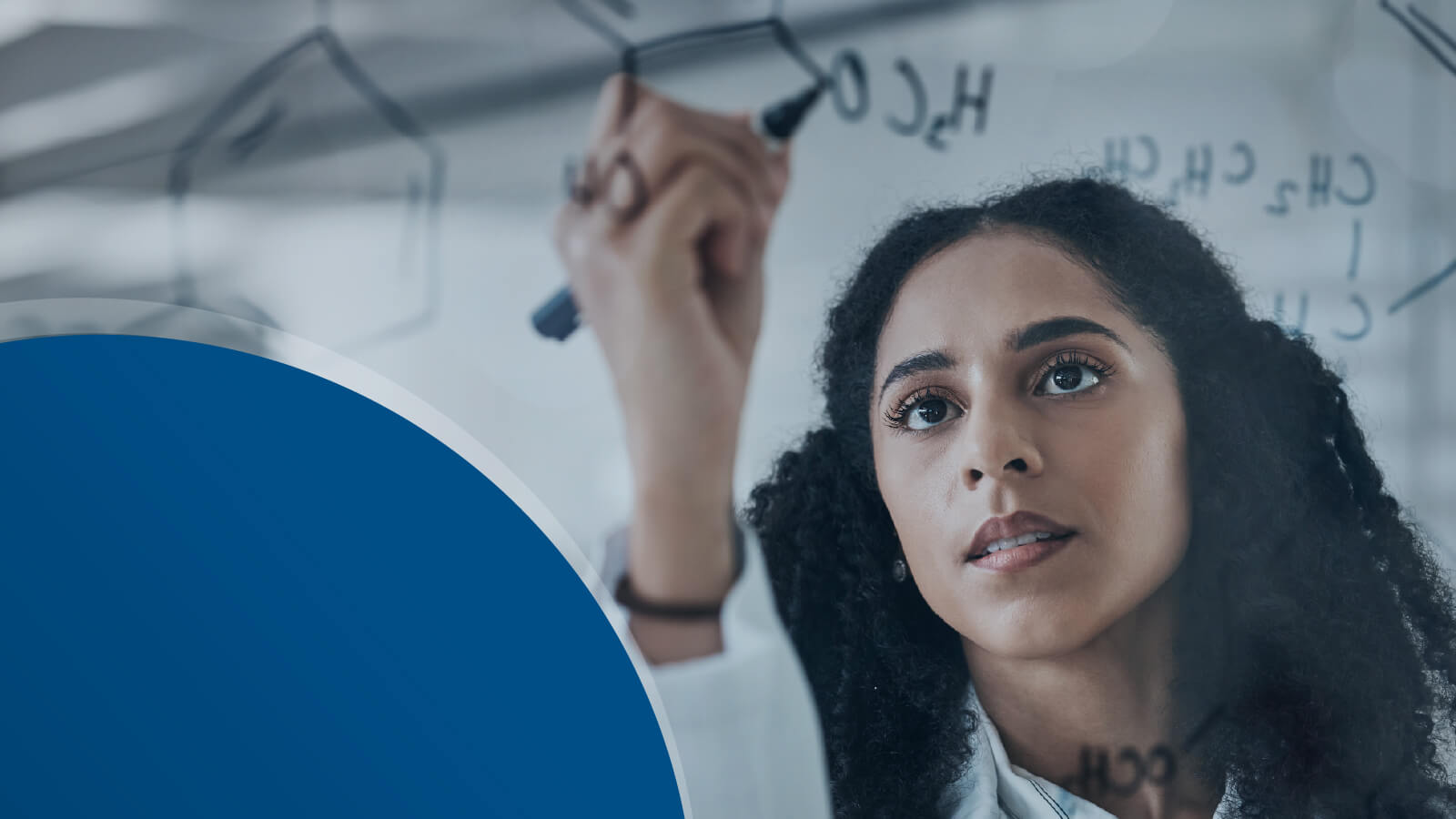 Researcher writing on a transparent board