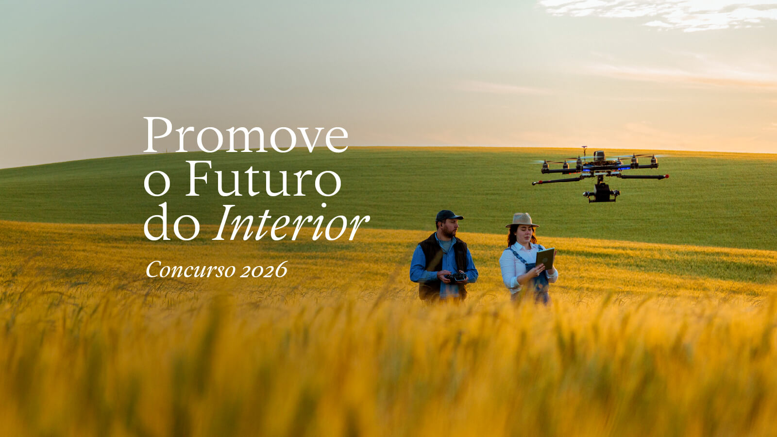 Two agricultural engineers operating a drone in a cultivated field